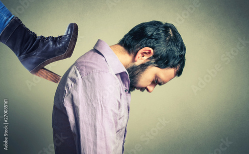 Female boot over the man's head. Violence