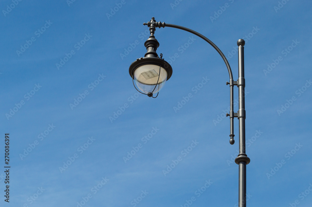 Old-fashioned street light with energy saving light bulb. Eco energy saving light lantern. Saving, accounting and financial concept. Old-fashioned street light with energy saving light bulb. Eco energy saving light lantern. Saving, accounting and financial concept.