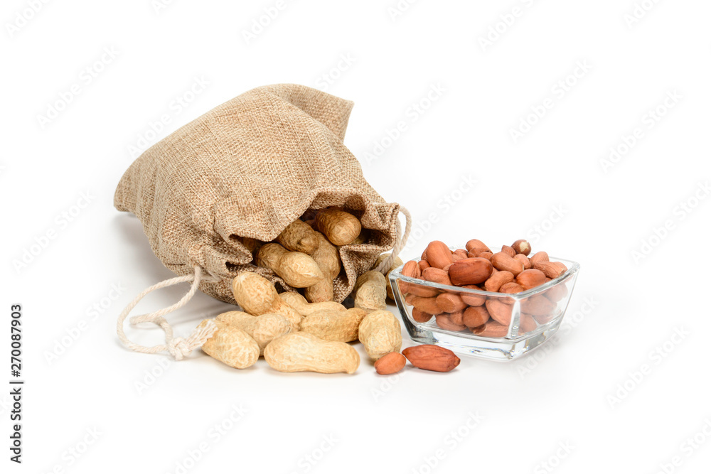 Peanuts. Jute burlap sack full of peanuts and glass bowl with peeled kernels, isolated on white background with shadows. Peanuts. Jute burlap sack full of peanuts and glass bowl with peeled kernels, isolated on white background with shadows.