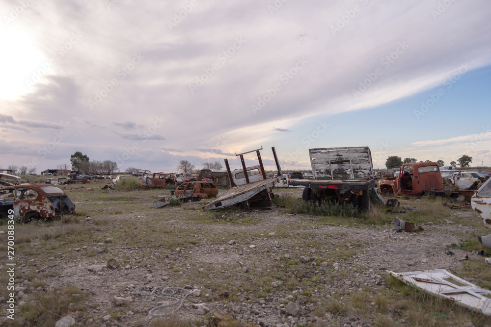 Old damaged cars on the junkyard waiting. Cemetery of cars. Old damaged cars on the junkyard waiting. Cemetery of cars.