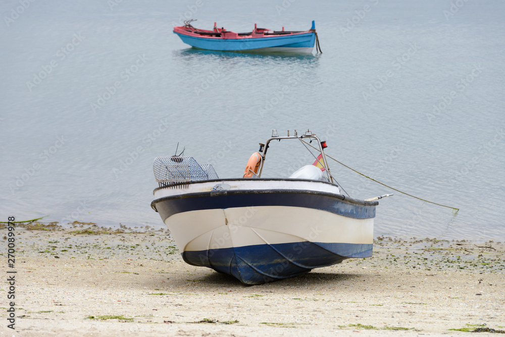 wooden fishing boat moored on the shore