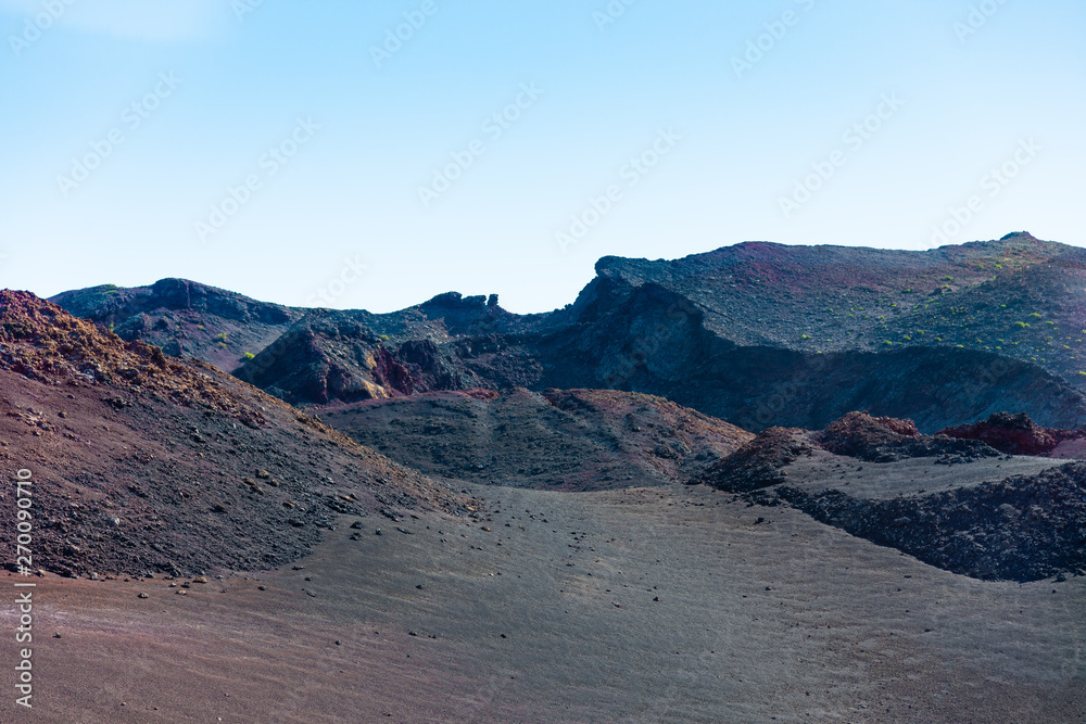 Timanfaya National Park, Lanzarote, Canary Islands, Spain. Unique panoramic view of spectacular lava river flows from a huge volcano crater creates a lunar landscape on planet earth.