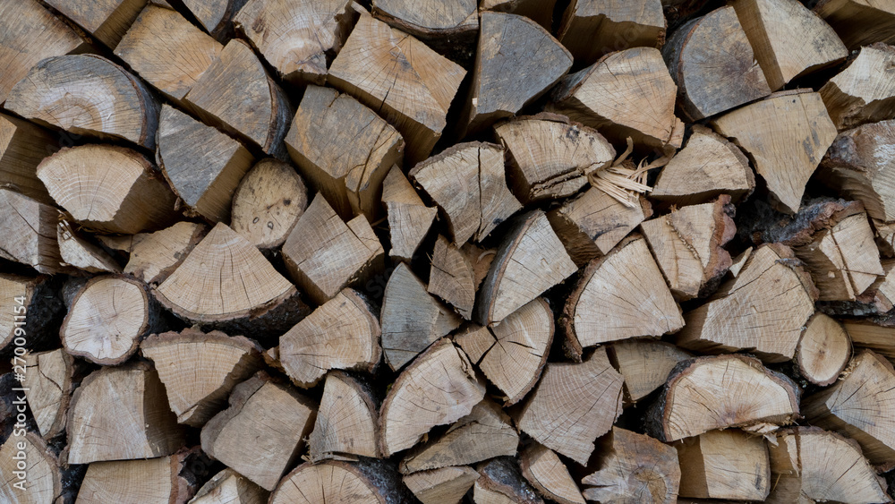 Wood is dried before being made into charcoal.Lumber. Fire logs. Firewood natural background. Woodpile in sawmill Wood is dried before being made into charcoal.Lumber. Fire logs. Firewood natural background. Woodpile in sawmill