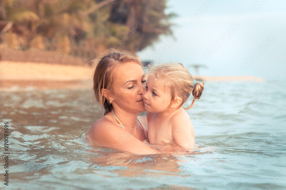 Child mother together swimming in sea authentic family vacation lifestyle Child mother together swimming in sea authentic family vacation lifestyle