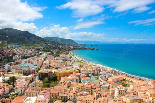 Amazing seascape of Sicilian Cefalu in Italy taken from adjacent hills overlooking the bay. The beautiful city on Tyrrhenian coast is popular summer holiday spot. Taken on sunny day with light clouds © ppohudka