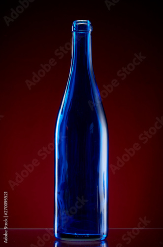 Dark glass bottle on red background