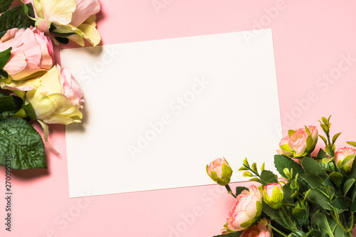 Fototapeta Naklejka Na Ścianę i Meble -  Empty paper sheet and flowers on pink background.
