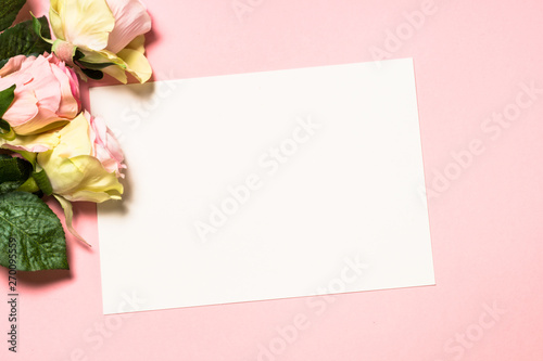 Empty paper sheet and flowers on pink background. © nadianb