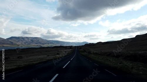 Driving through beautiful iceland with clouds and mountains