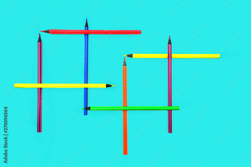 Back to school background with neon colors pencils on pastel blue backdrop. Flat lay, top view, copy space. Back to school background with neon colors pencils on pastel blue backdrop. Flat lay, top view, copy space.