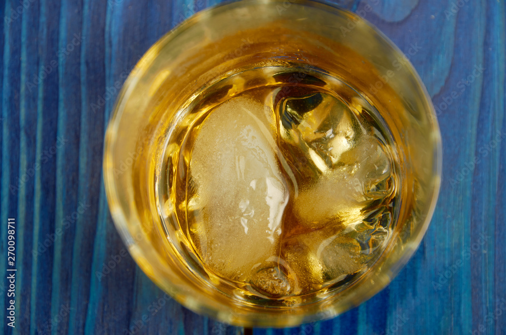 A glass of strong alcohol with ice in a transparent glass A glass of strong alcohol with ice in a transparent glass