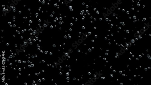 Bubbles of champagne rise up colliding with each other on a black background.