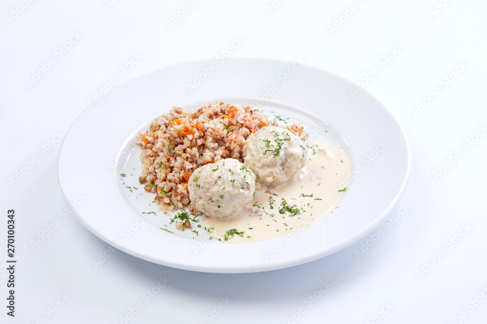 meatballs with buckwheat and sauce on the white meatballs with buckwheat and sauce on the white