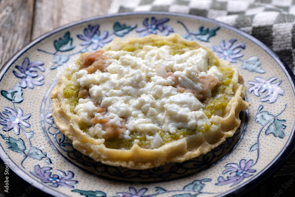Mexican food: sopes with green sauce and beans