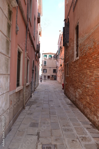 Street in Venice, ancient buildings and pavement.