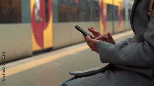 close up of a woman using a travel application for catching her train to the holiday destination. Be connected with people when you travel abroad. Easy way to have your train ticket on your phone