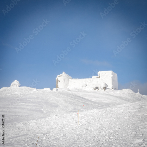 The destroyed Polish observatory is covered with snow on the top in the Carpathians