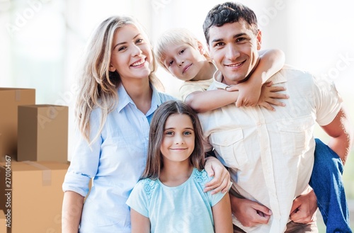 Beautiful smiling family sitting at sofa at home