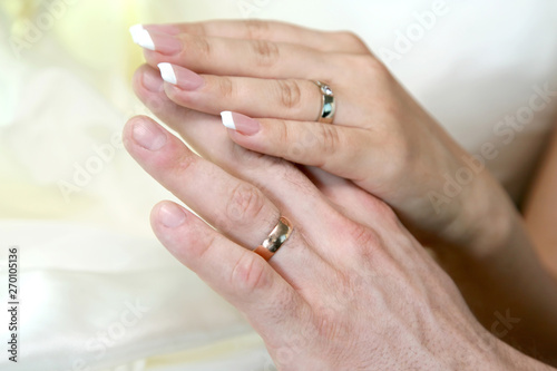 hands of the bride and groom together. love and family relationships