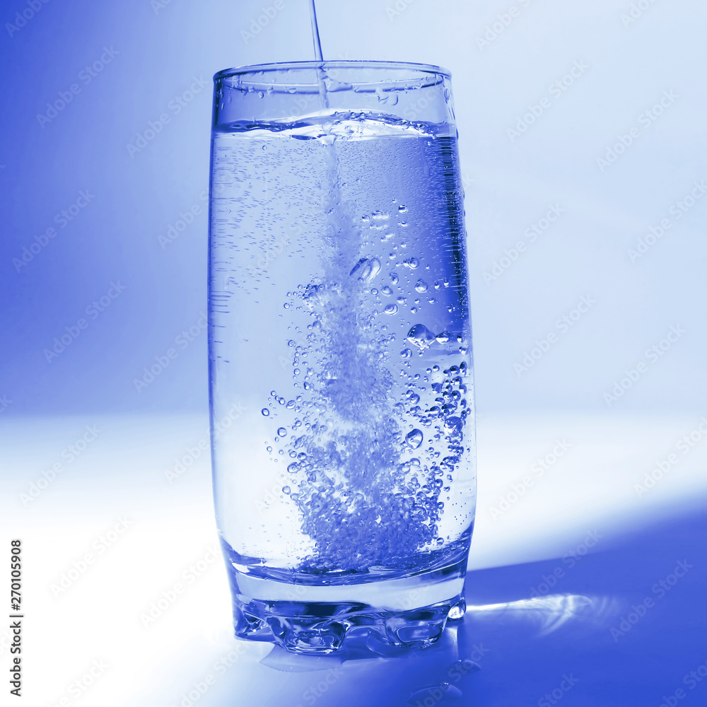 water pouring in transparent glass with bubbles of air water pouring in transparent glass with bubbles of air