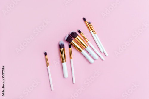 Set of makeup brushes on pink background. Top view point, flat lay. Top view