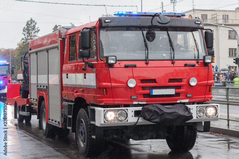 Fire brigade workers are riding fire truck on military parade