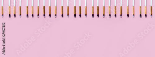 Set of makeup brushes on pink background. Top view point  flat lay. Top view