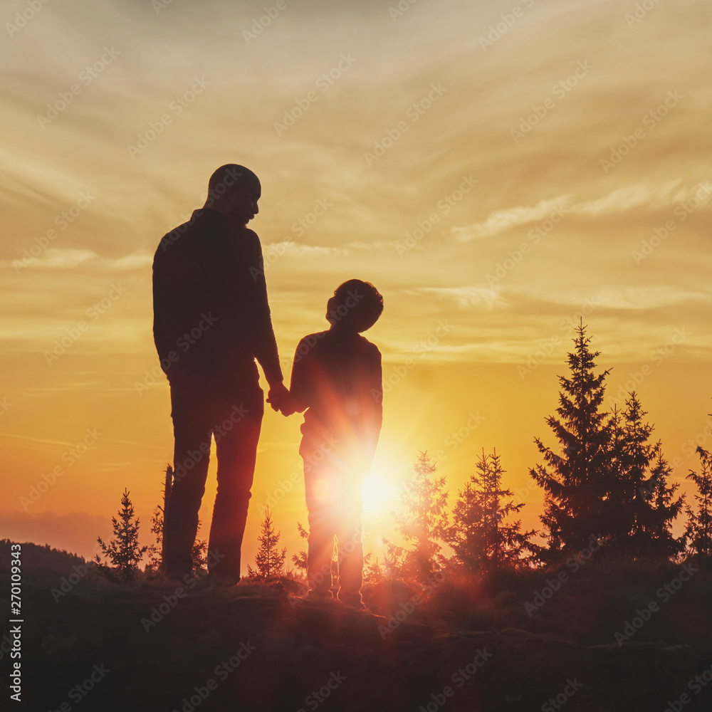 Father and son in sunset