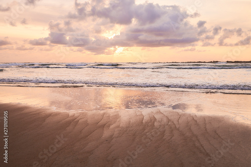 Beach of moledo at the end of the day  with a view to trega mountain on spanish side of the border. Low tide displaying the sandy beach on a cloudy day.