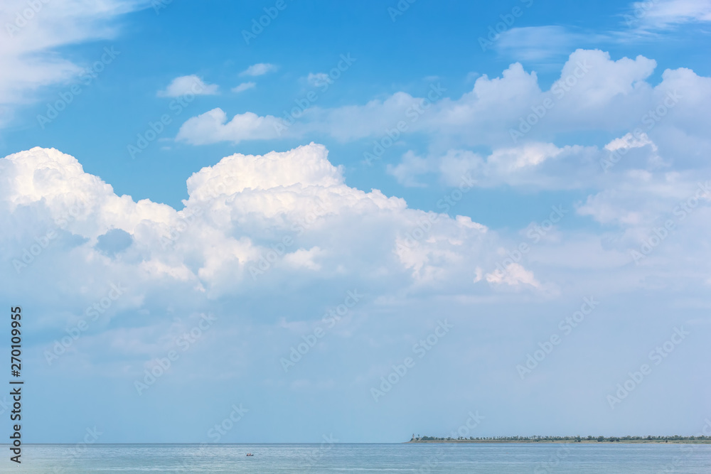 Picturesque seascape with white clouds above the sea