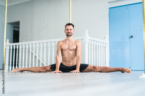 Pole dance young male athlete