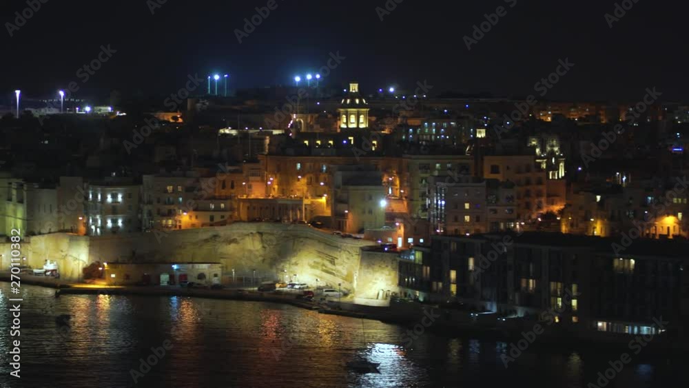 Panoramic night view of a coast line and the downtown of Valletta, Malta with different landmarks of the city in 4k Panoramic night view of a coast line and the downtown of Valletta, Malta with different landmarks of the city in 4k