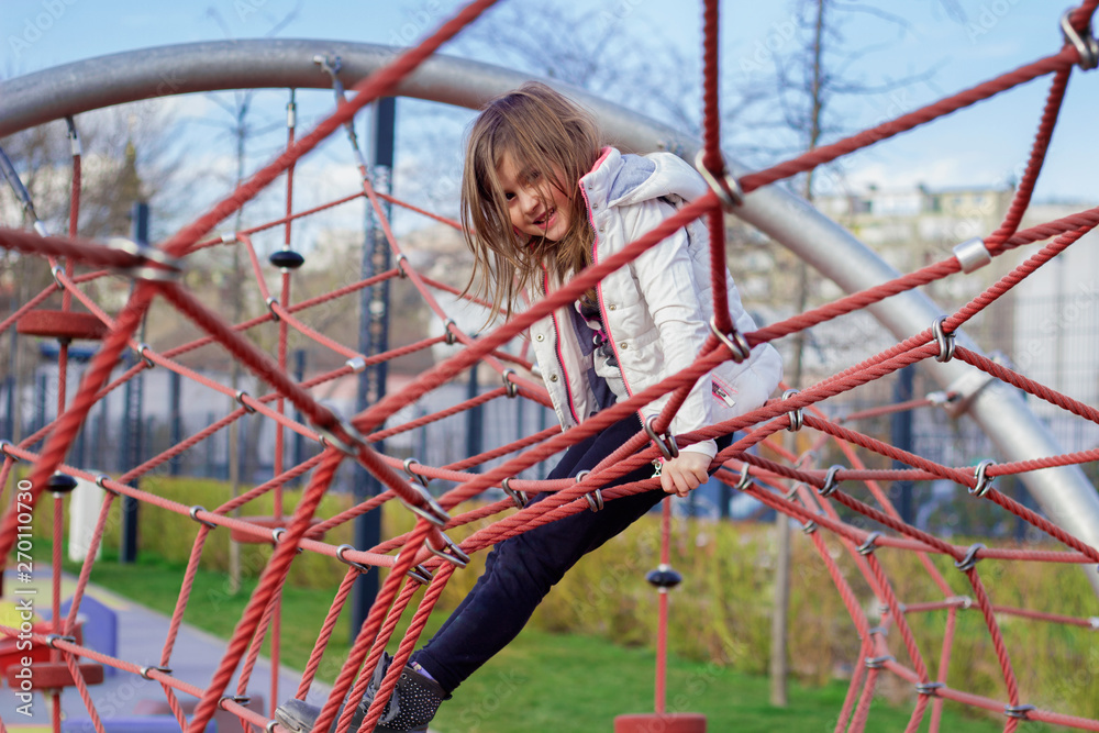 Cute little girl playing on the playground