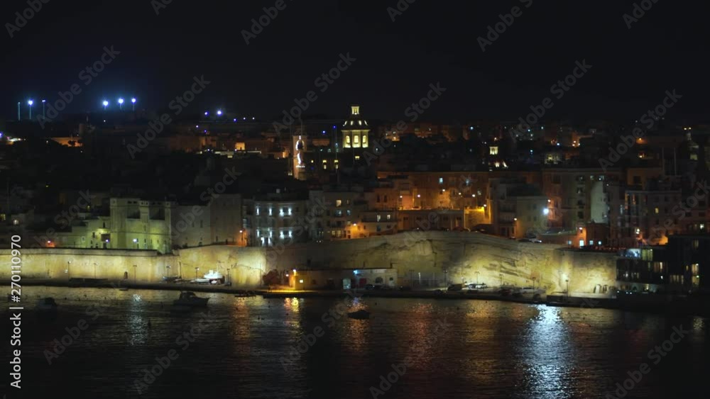 Panoramic night view of a coast line and the downtown of Valletta, Malta with different landmarks of the city in 4k Panoramic night view of a coast line and the downtown of Valletta, Malta with different landmarks of the city in 4k