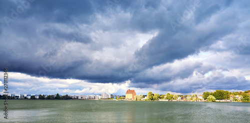 Old storage and development area at the Ziegelsee in Schwerin under dramatic clouds. Mecklenburg-Vorpommern, Germany photo