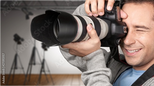 Male Photographer with Camera on background