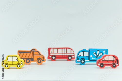 wooden retro typewriter toy on a light background. group of cars with empty space. close-up. educational toys for children. vintage