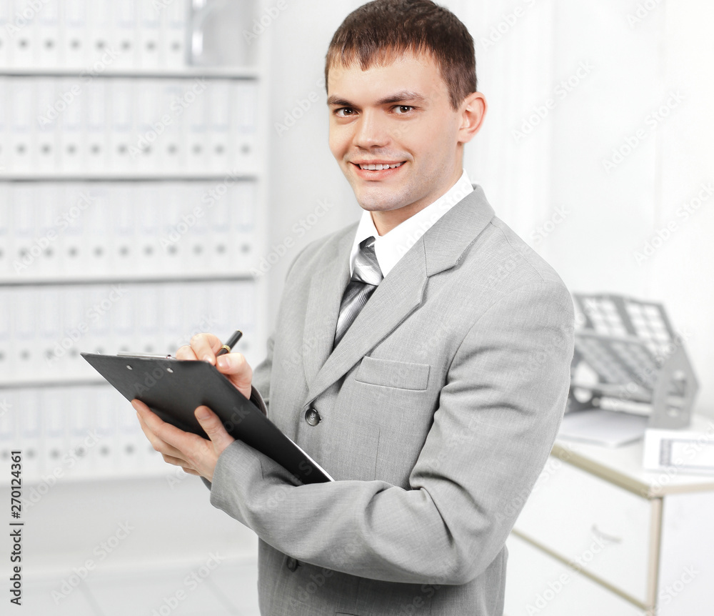 young businessman makes an entry in the diary . young businessman makes an entry in the diary .