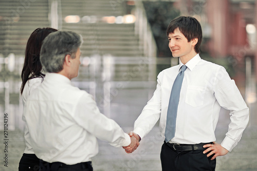 Manager welcomes the client with a handshake