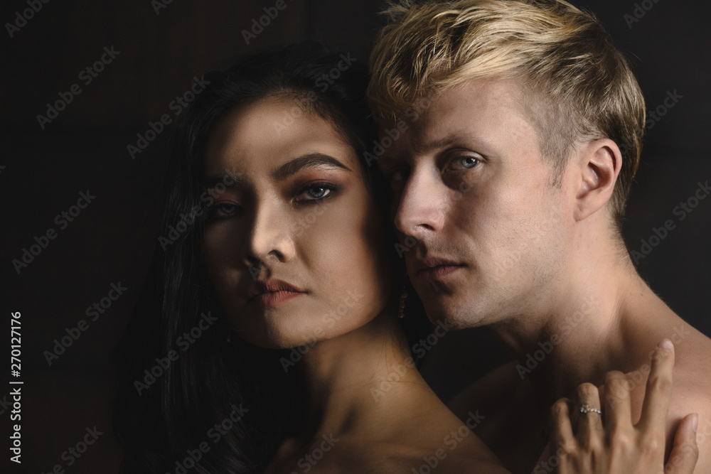 portrait of Caucasian male and Asian female having romance moment portrait of Caucasian male and Asian female having romance moment