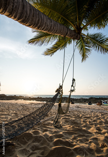 Beach cradle under coconut tree with clear sky
