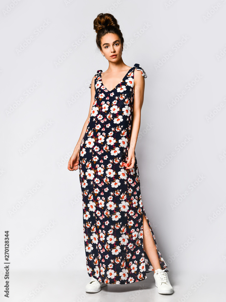 Woman in Long Floral Dress in Fashion Store - Portrait of girl in a clothes shop in a maxi summer dress Woman in Long Floral Dress in Fashion Store - Portrait of girl in a clothes shop in a maxi summer dress