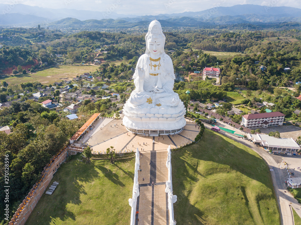 Aerial view of Big Buddha (Guan Yin Buddha) in Wat Huay Pla Kung temple. Tourist attraction landmark in Chiang Rai province of Thailand.