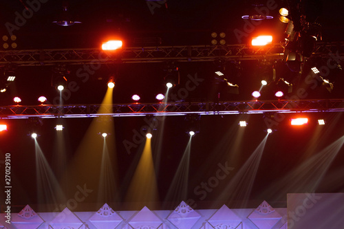 Performance moving lighting on construction light beam ray downward in yellow blue color, on Concert and Fashion Show stage ramp. LED par new technology to save power more color and high density Light photo