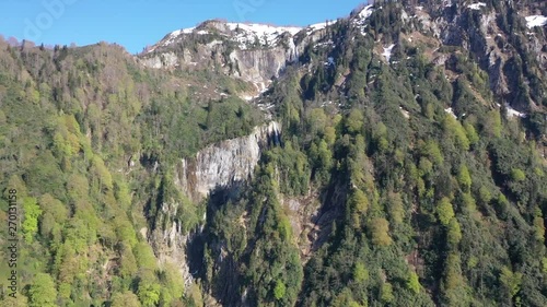 Snowy mountains and waterfalls neighboring the sky. photo