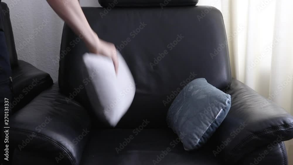 Arranging pillows on the armchair Arranging pillows on the armchair