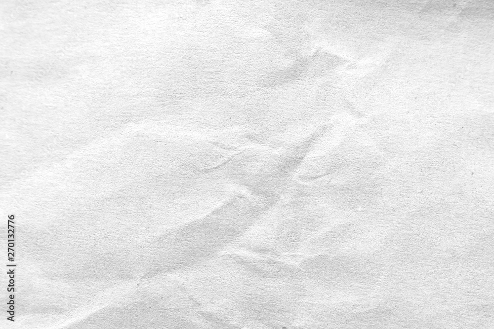 Fototapeta premium White crumpled paper texture background. Close-up.