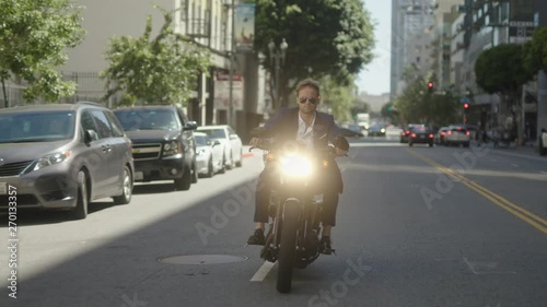 Wallpaper Mural Businessman drives old school motorcycle on streets of downtown. Speed driving. Reaching a destination. Torontodigital.ca