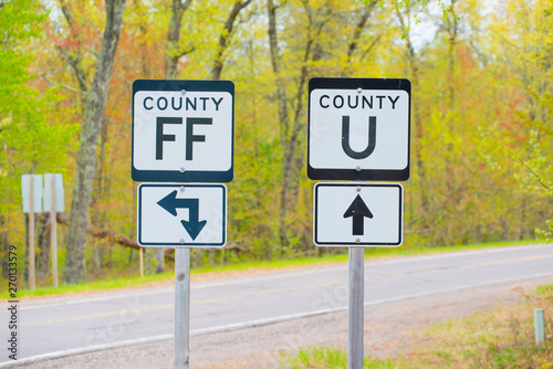 County road sign 'FF' and 'U' with Spring trees in background - taken rural Wisconsin
