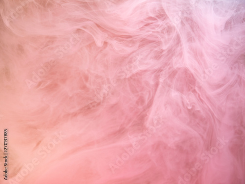 Abstract pink smoke swirling under water, close up view. Blurred background. Acrylic paint dissolving into water, abstract pattern. Pink ink dropped into liquid, abstract art background